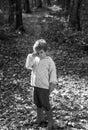 Boy in rubber boots walking in forest. Cute tourist concept. Forest school is outdoor education delivery model in which