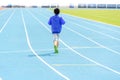 Boy run in blue track