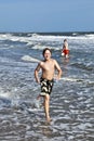 Boy running along the beach