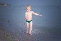 Boy running along the water on the beach Royalty Free Stock Photo