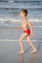 Boy running on the beach Royalty Free Stock Photo
