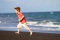 Boy running at black sand beach Royalty Free Stock Photo