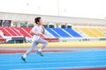 Boy running on blue track Royalty Free Stock Photo