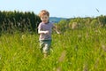 Boy running down a meadow Royalty Free Stock Photo