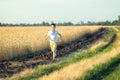 Boy is running in the field of wheat. Summer