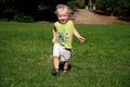 Boy Running on Grass in Park