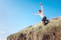 Boy running and jumping over sand dunes on beach vacation background Royalty Free Stock Photo