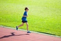 Teenager boy running on race track. Kids run.