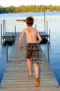 Boy running to the lake Royalty Free Stock Photo