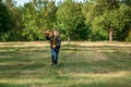 A boy runs across the field and launches a toy airplane against the backdrop of greenery. The concept of dreams, choice of Royalty Free Stock Photo