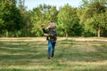 A boy runs across the field and launches a toy airplane against the backdrop of greenery. The concept of dreams, choice of Royalty Free Stock Photo