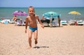 Boy runs on a beach