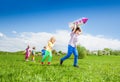 Boy runs with rocket toy and kids chasing after Royalty Free Stock Photo