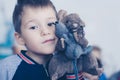 Boy`s face with a toy mouse, close-up