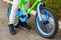 The boy`s feet on the children`s bike close