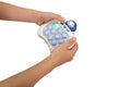 Boy's hand holding bubble button game on white background Royalty Free Stock Photo