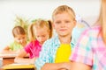 Boy's portrait in classroom with other pupils Royalty Free Stock Photo