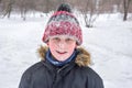 A boys portrait in winter time. A close-up. The whole face in the snow