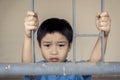 Boy sad behind the iron bar Royalty Free Stock Photo