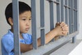 Boy sad behind the iron bar Royalty Free Stock Photo