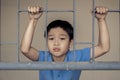 Boy sad behind the iron bar Royalty Free Stock Photo