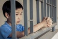 Boy sad behind the iron bar Royalty Free Stock Photo