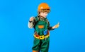 Boy in safety helmet and toolbelt with hammer. Child in builder uniform with tools for repair. Little repairman Royalty Free Stock Photo