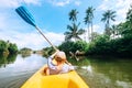 Boy sailing in canoe boat on tropical lagoon Royalty Free Stock Photo