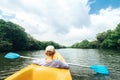 Boy sailing in canoe on tropical lagoon Royalty Free Stock Photo