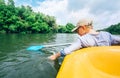 Boy sailing in canoe on tropical lagoon - active leisure time Royalty Free Stock Photo