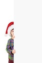 Boy in Santa hat behind a white blank Royalty Free Stock Photo