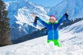 Boy with Santa hat and big smile stand in snow over mountains Royalty Free Stock Photo