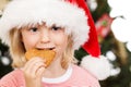 Boy in Santa hat eating gingerbread Royalty Free Stock Photo