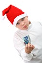 Boy in Santa hat with paper money isolate on white Royalty Free Stock Photo