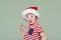 Boy in Santa hat. Surprise and amazement on his face Royalty Free Stock Photo