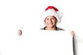 Boy in Santa`s hat surprised and holding white blank billboard for greetings. Isolated on white Royalty Free Stock Photo