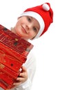 Boy in Santa's red hat carrying three presents