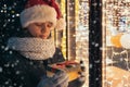 Boy in Santas hat with gifts box looking and dreaming Royalty Free Stock Photo