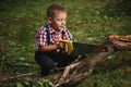 Boy sawing fallen tree in garden Royalty Free Stock Photo