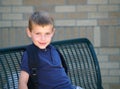 Boy at school bus stop Royalty Free Stock Photo