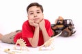 The boy the school student the brunette in a red t-shirt lies on Royalty Free Stock Photo