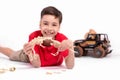 The boy the school student the brunette in a red t-shirt lies on Royalty Free Stock Photo