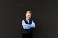 Boy in school uniform smiling, back to school