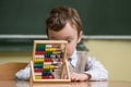 Boy in school working with abacus Royalty Free Stock Photo
