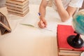 A boy schoolboy does his homework. Textbooks and notebooks on the table Royalty Free Stock Photo