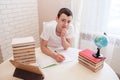 A boy schoolboy does his homework. Textbooks and notebooks on the table