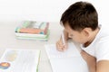 Boy schoolboy teaches lessons writing in notebook and reading books