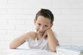 Boy schoolboy teaches lessons writing in notebook and reading books