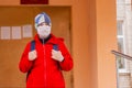 Boy schoolboy walks out of school wearing protective mask