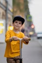 Boy with scooter. Happy ride around the city